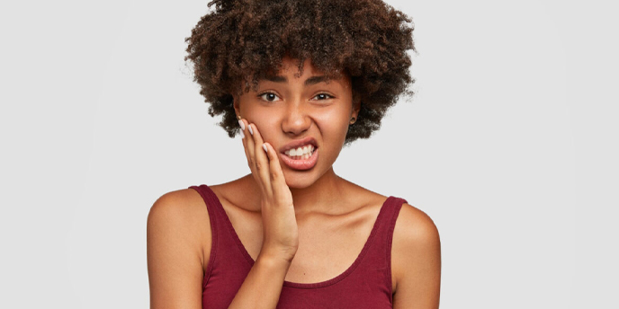 A lady experiencing Tooth pains